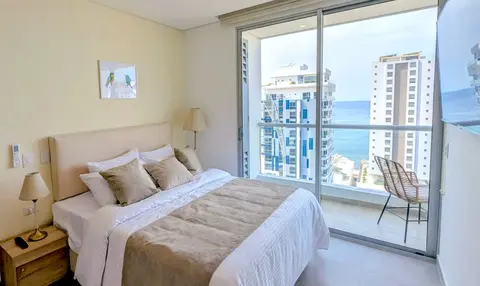 Romantic master bedroom with a plush bed and warm lighting.